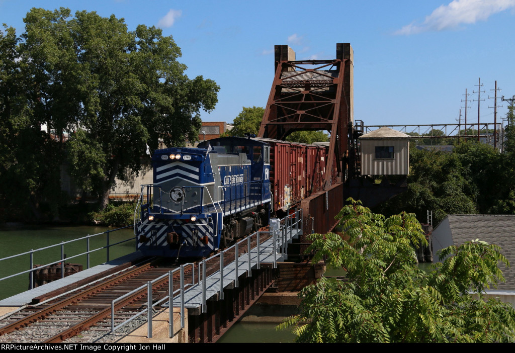 1501 pulls across the Black River bridge while picking up two more cars